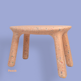 Cork stool with a speckled pattern on a solid background