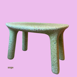 Speckled green childrens play table on a pink background