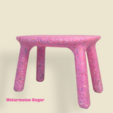 Pink children table with speckled pattern on a beige background