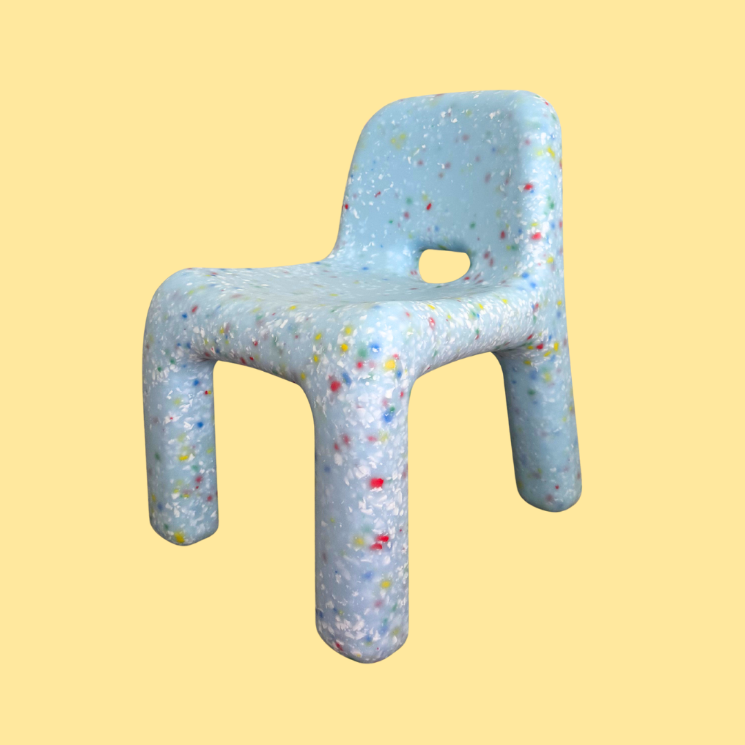 Children's chair with colorful speckles on a yellow background