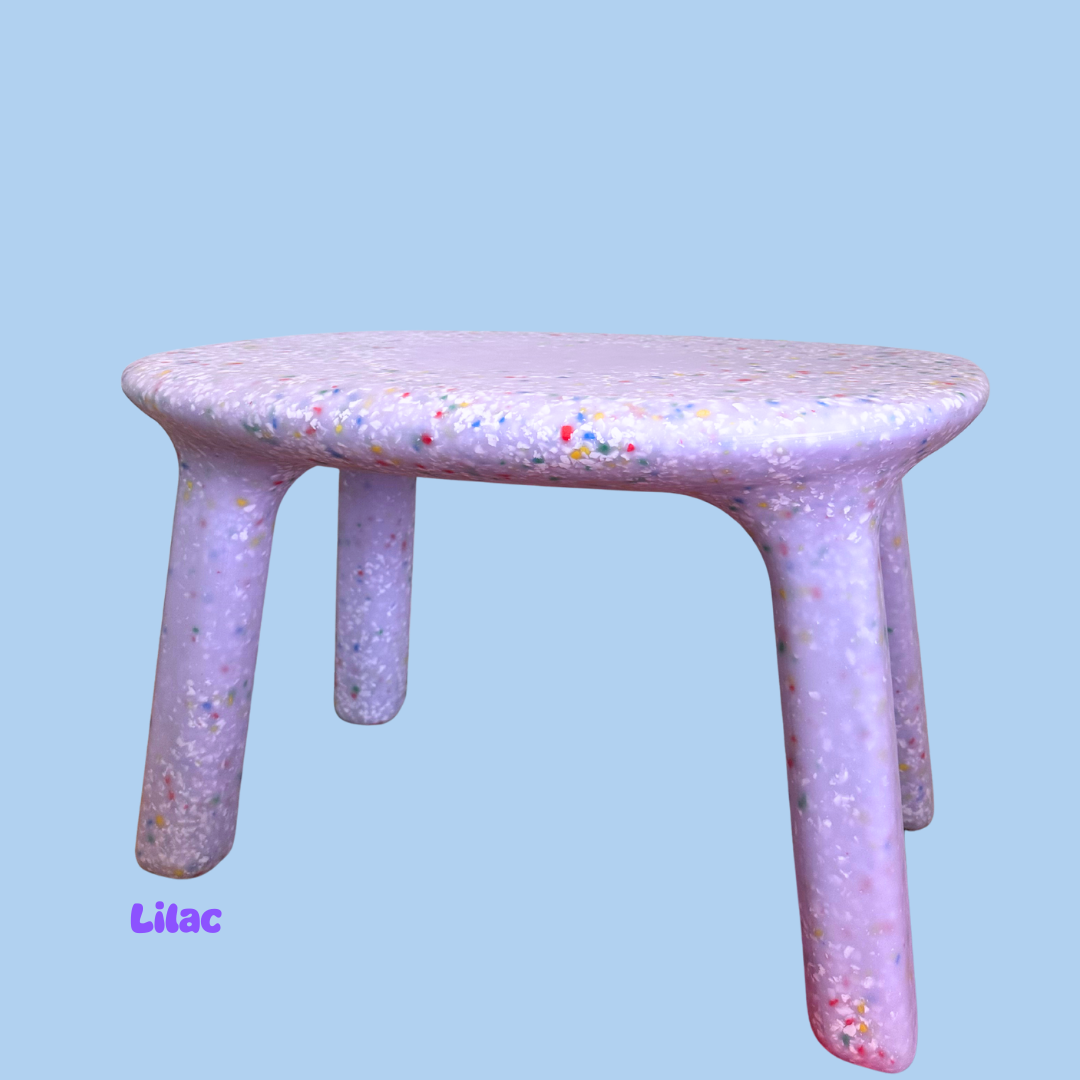 Lilac stool with a speckled pattern on a light blue background