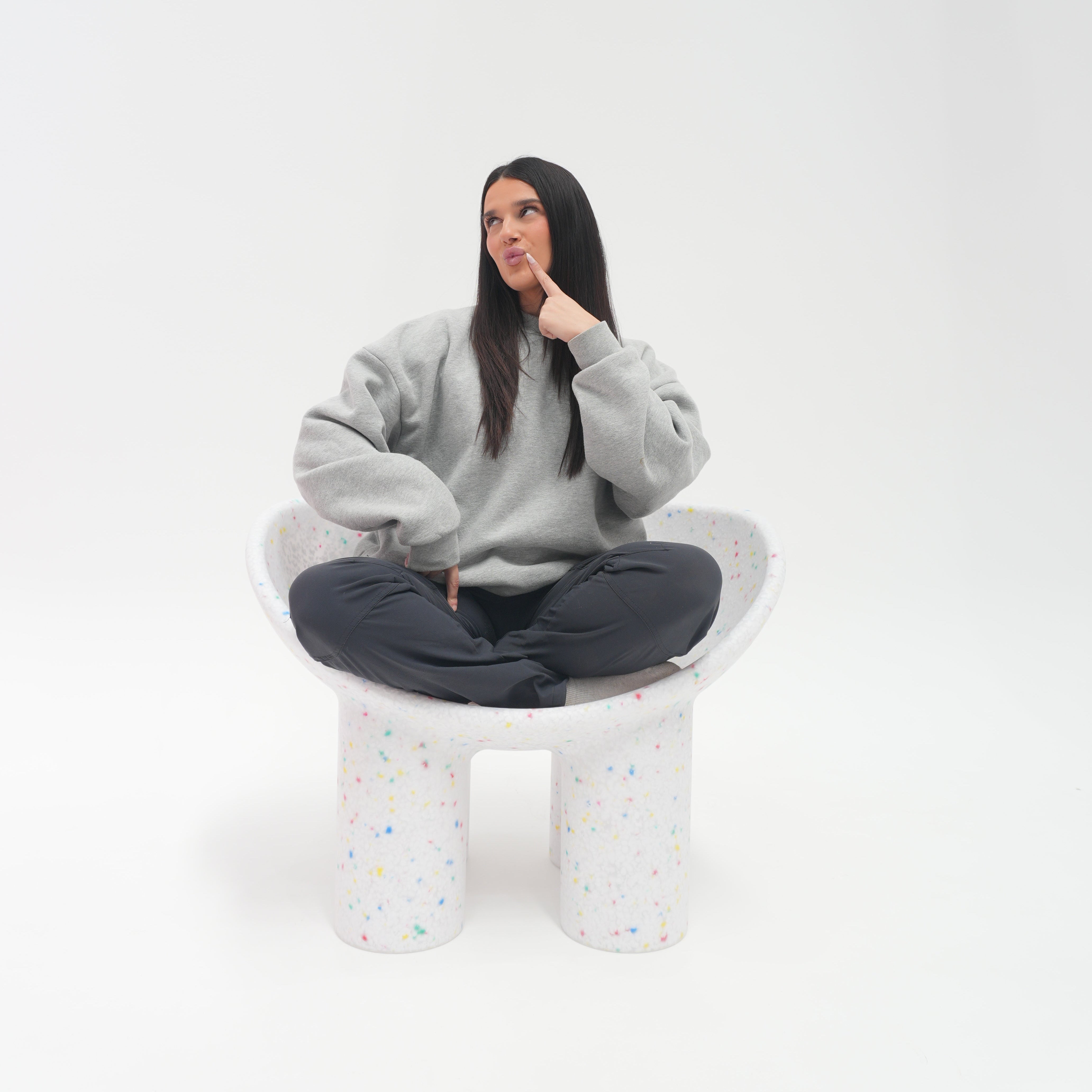 Person wearing a gray dress with a white background