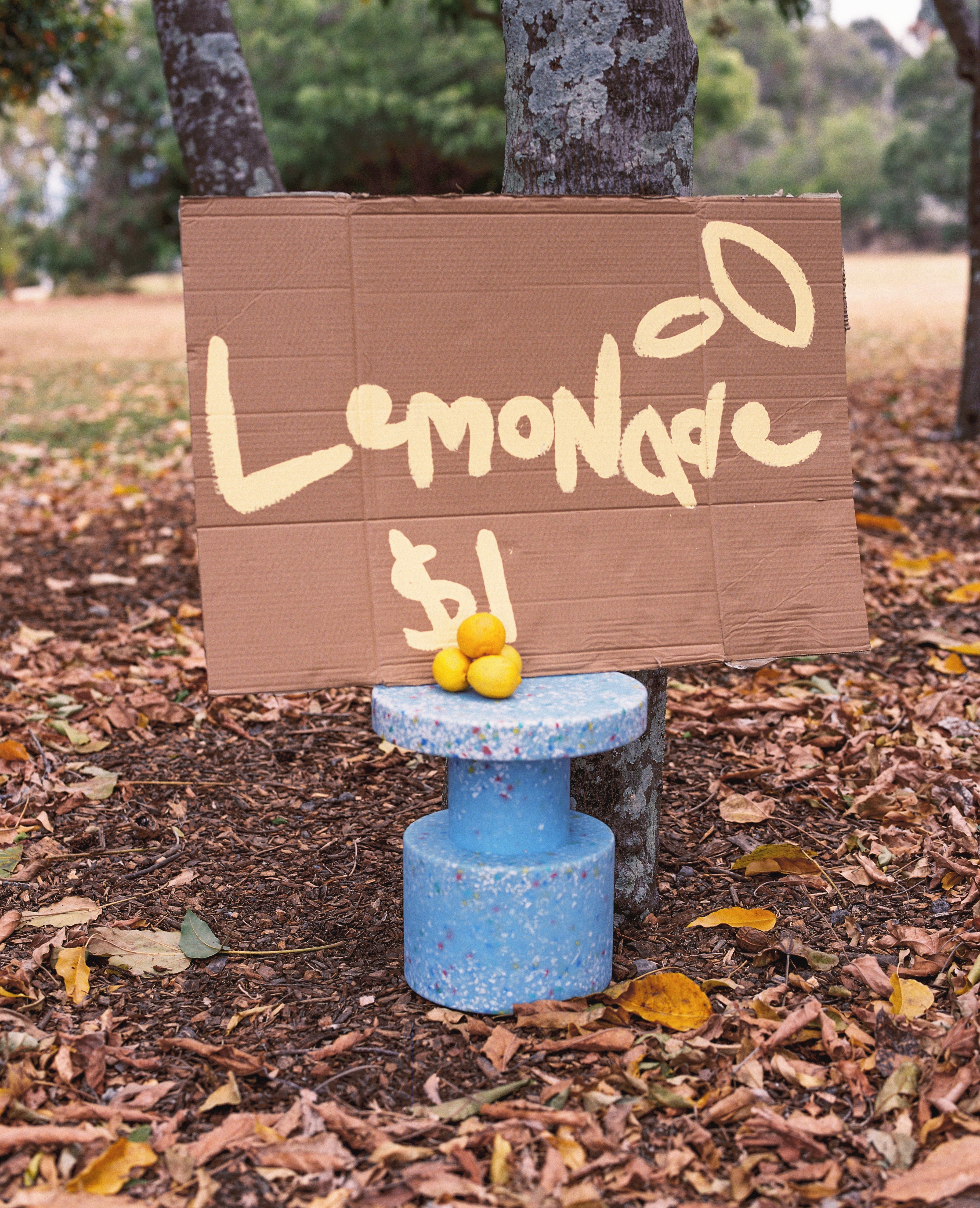 Child standing next to stacked Side tables