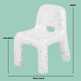 Kids chair with colorful speckles and measurements on a green background