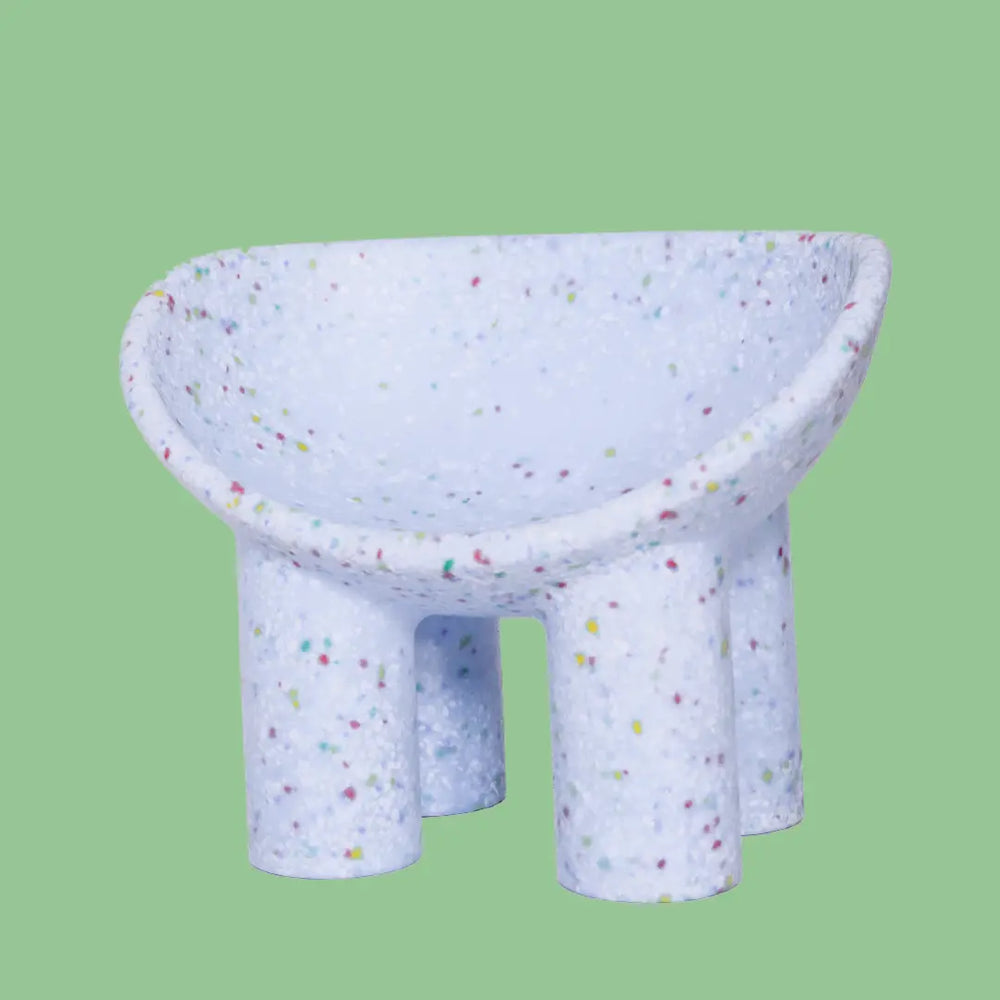 Lilac kids bucket chair on a green background