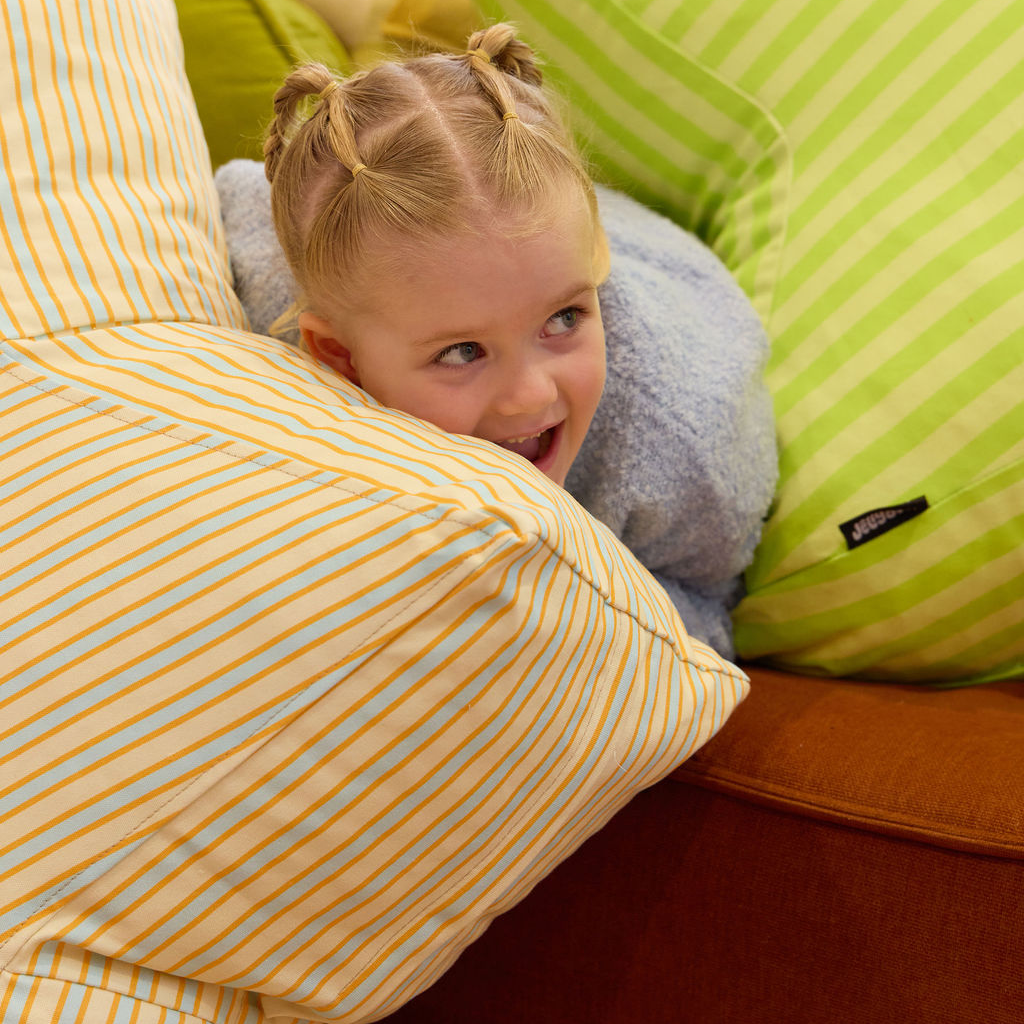 Child playing with Yellow, Blue and orage star shaped bean bag
