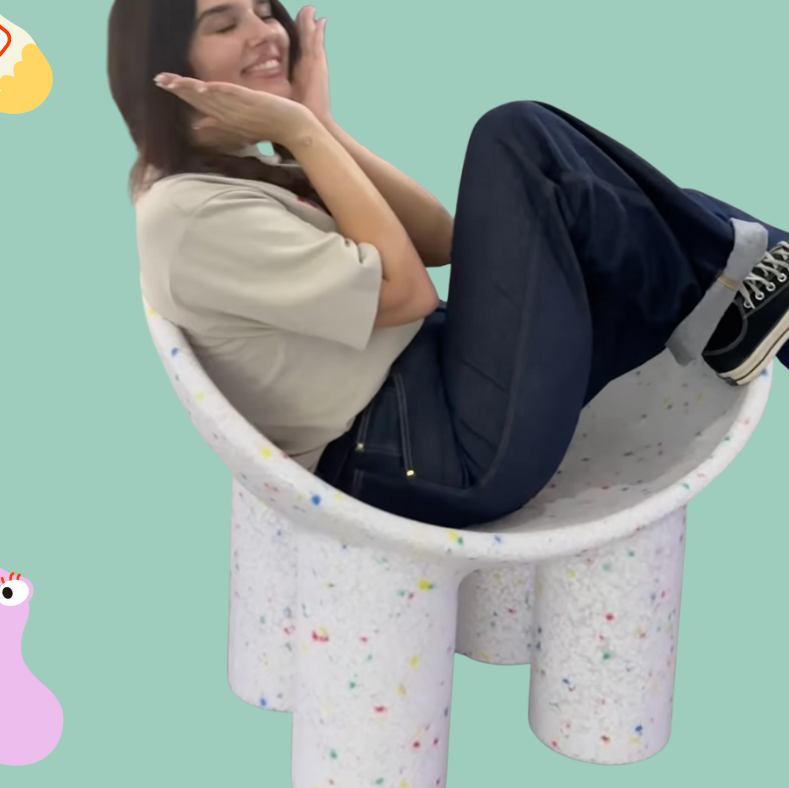 Person sitting on a colorful chair with a light green background