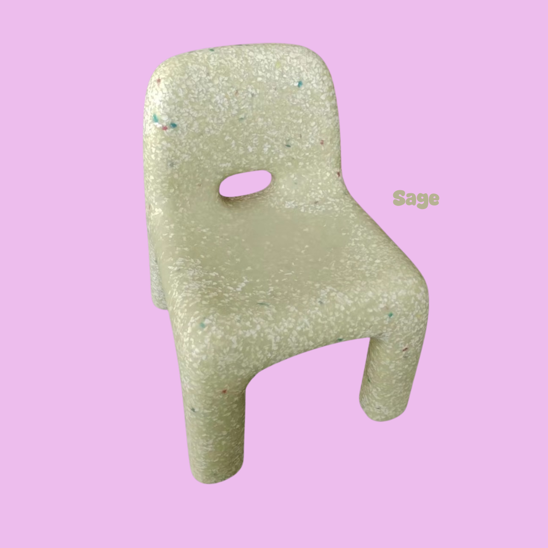 Green glittery chair on a pink background with 'Sage' text