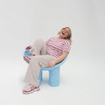 Girl sitting on Adult bucket chair