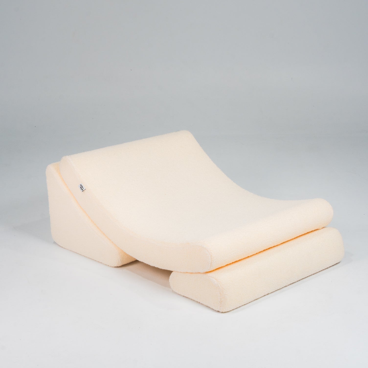 Beige wedge pillow on a gray background