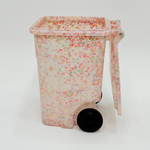 Decorative trash bin with colorful speckles on a white background