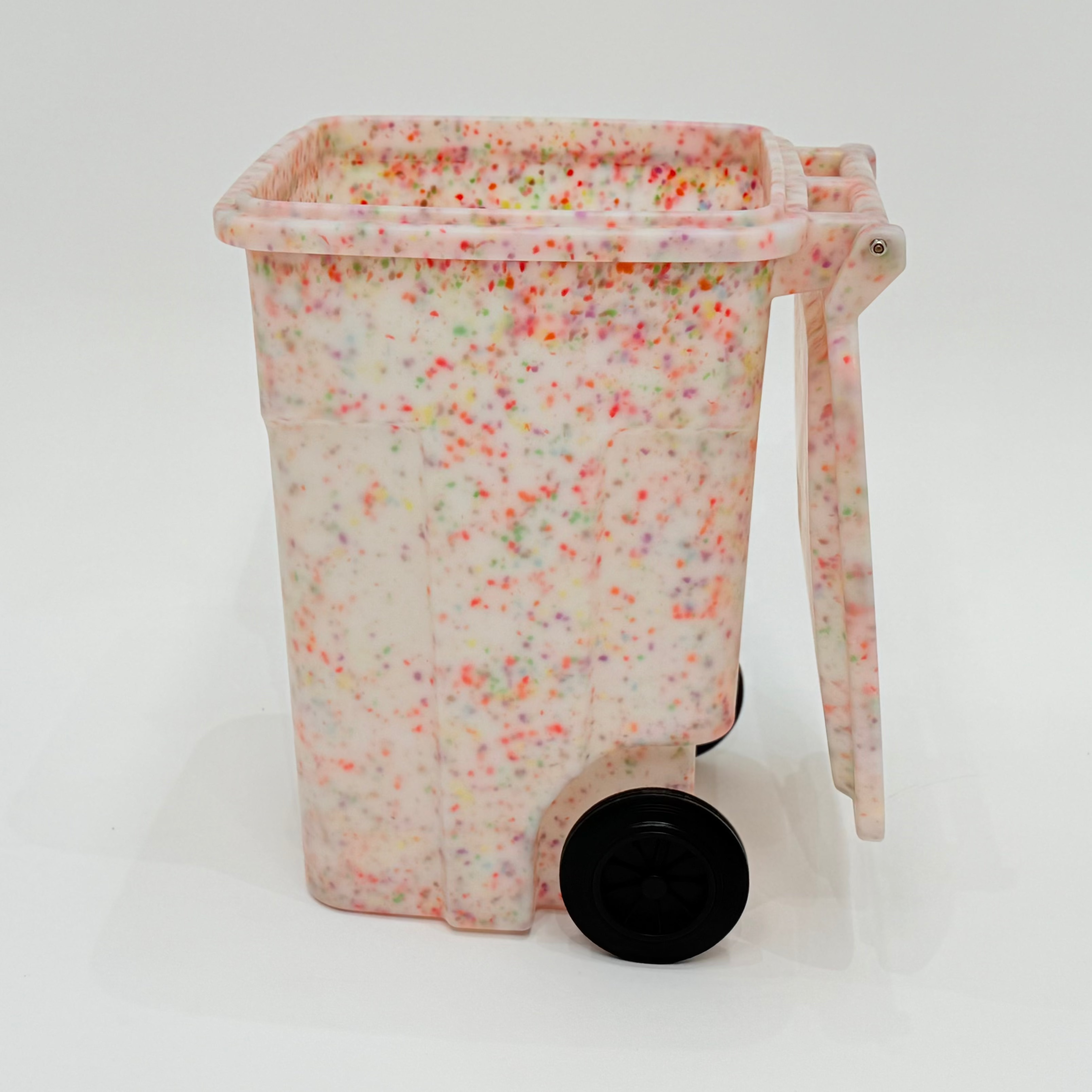 Decorative trash bin with colorful speckles on a white background
