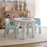 Children's table and chairs set in a playroom with toys and decor.