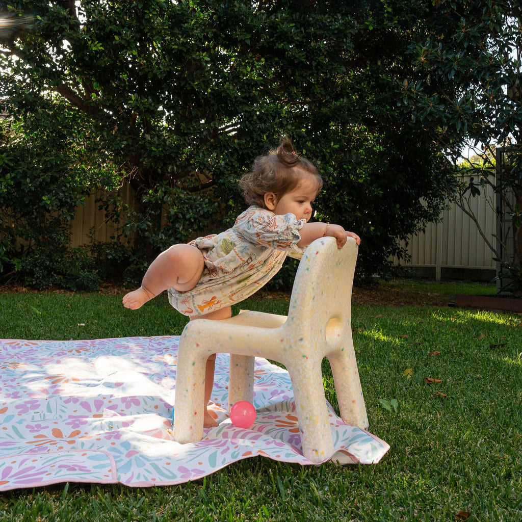Toddler climbing a Jellybean Interiors chair