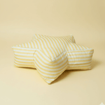 Large superstar floor cushion in a bright, sunny yellow fabric. A 36-inch star-shaped crash pad for kids' reading nooks, available in soft cotton or waterproof oxford.