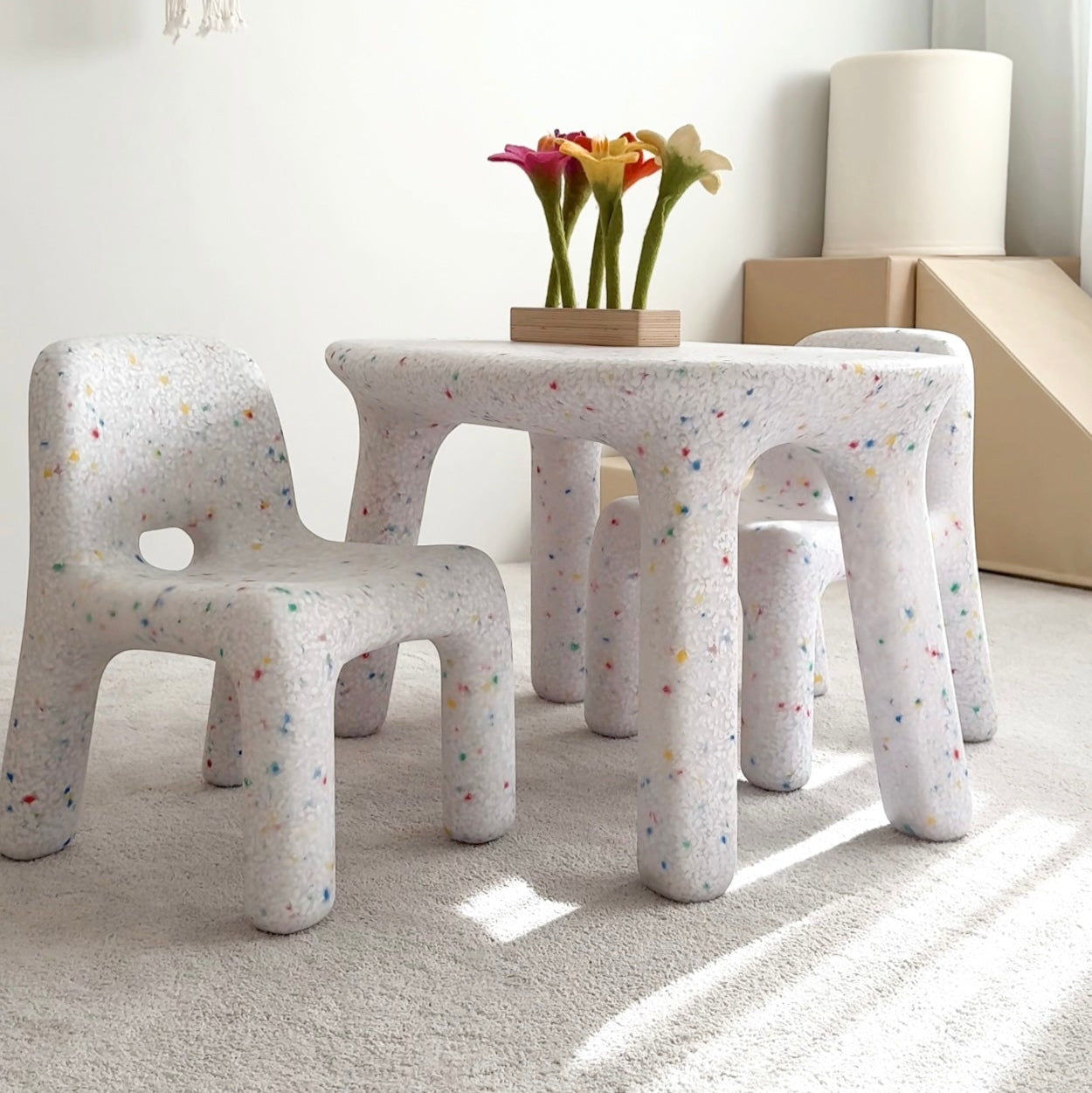 Children's furniture set with stools and a small table in a room with a basketball hoop on the wall.
