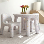 Children's furniture set with stools and a small table in a room with a basketball hoop on the wall.