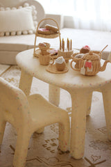 Children's plastic chair with wicker baskets and toys on a patterned rug