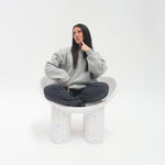 Person wearing a gray dress with a white background