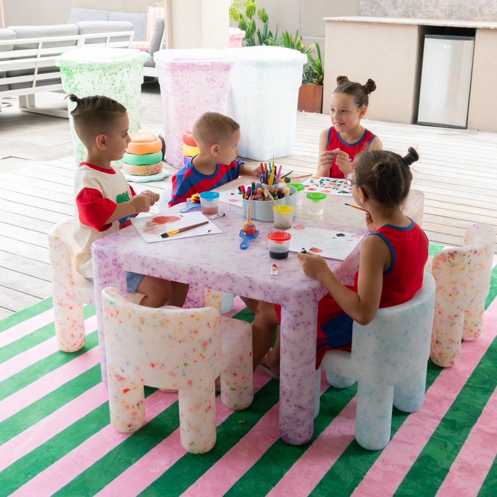 Four children creating together around a Pick N Mix table