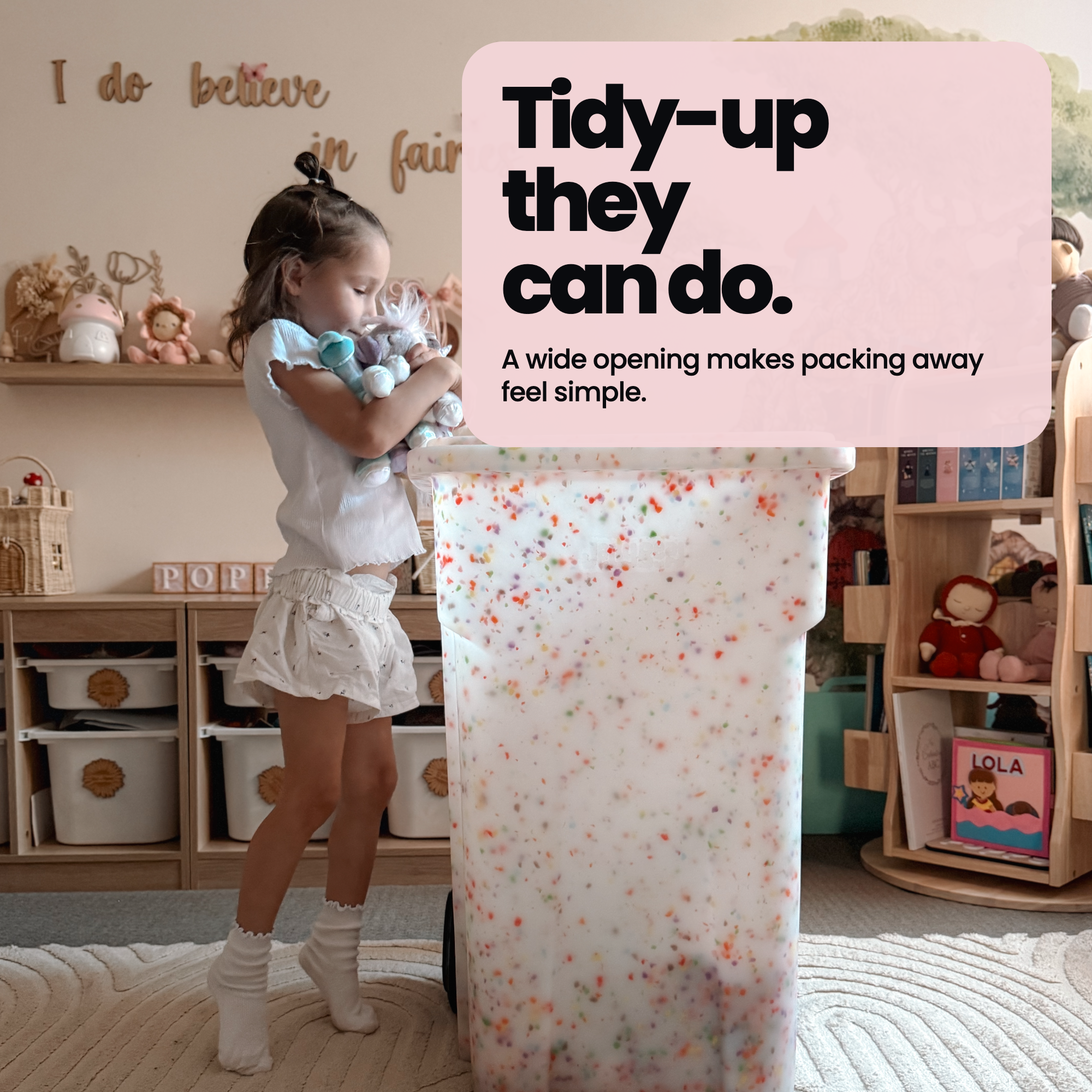 Child packing toys into an open Rollie Bin